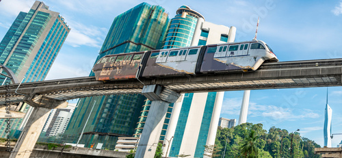 Canvas Print An LRT train,runs along the efficient overhead railway system,high above KL city center,avoiding busy roads below,Kuala Lumpur,Malaysia