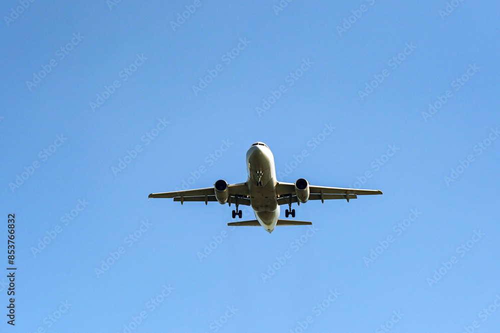 Unmarked holiday jet isolated against a blue sky. Travel concept. Copy space. Unmarked holiday jet isolated against a blue sky. Travel concept. Copy space.