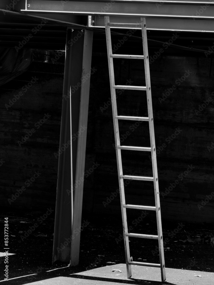 Interplay of Light and Shadow. Metal Ladders at Parking Spot Under Construction. Black and white. Monochrome. Interplay of Light and Shadow. Metal Ladders at Parking Spot Under Construction. Black and white. Monochrome.