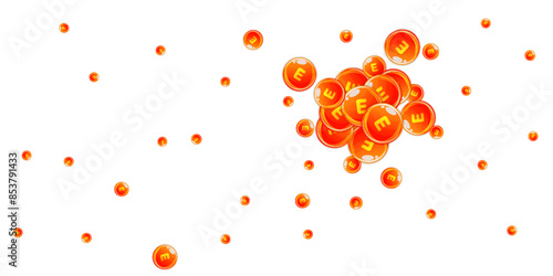 Vitamin E round capsules scattered randomly.