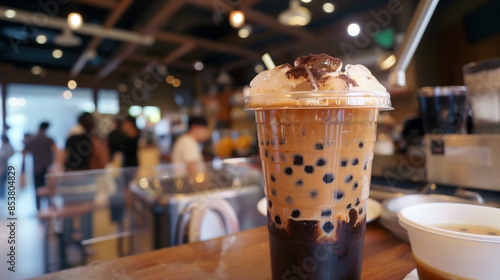 Bubble tea with tapioca pearls, caramel drizzle, and ice cubes. © tiagozr