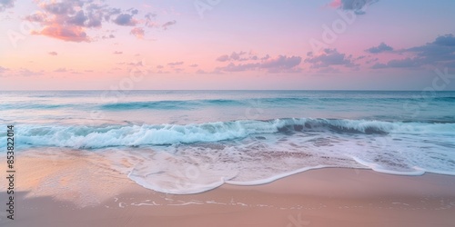 The photo shows a beautiful beach with soft pink sand and gentle waves.