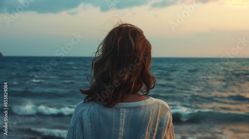 Rear view of a woman looking at the sea