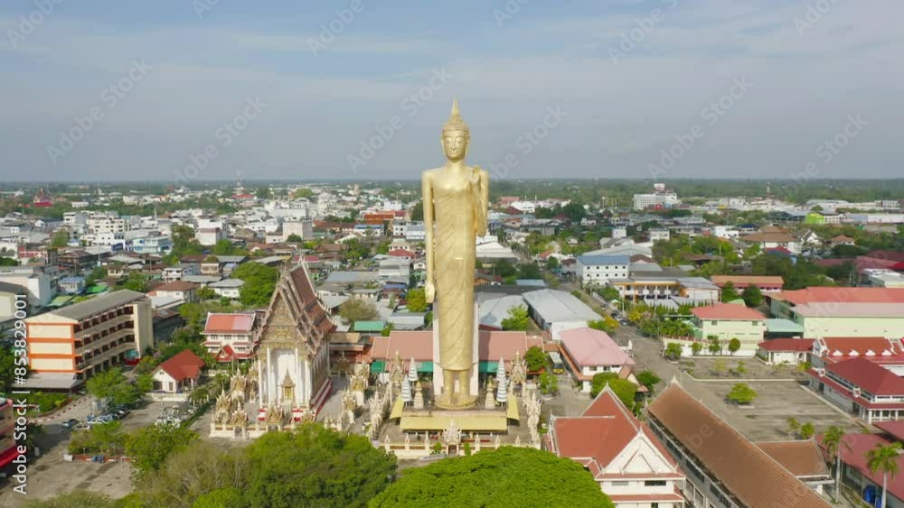 Aerial view of standing buddha statue in temple from above. Top view. Real estate in Roi et province city, Thailand. Property real estate. Aerial view of standing buddha statue in temple from above. Top view. Real estate in Roi et province city, Thailand. Property real estate.
