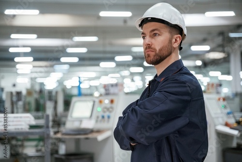 Smart employee. Factory worker is indoors with hard hat © standret