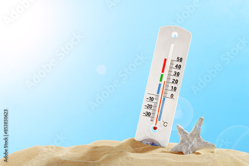 White Thermometer Sticking Out of Sand on a Sunny Day