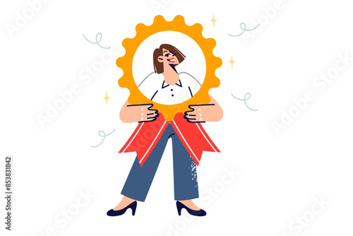 Business woman best employee holds large medal, showing off award for professional achievements