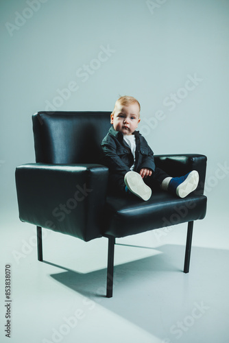 Little stylish boy, 1 year old child in shirt and white t-shirt. Stylish clothes for babies.