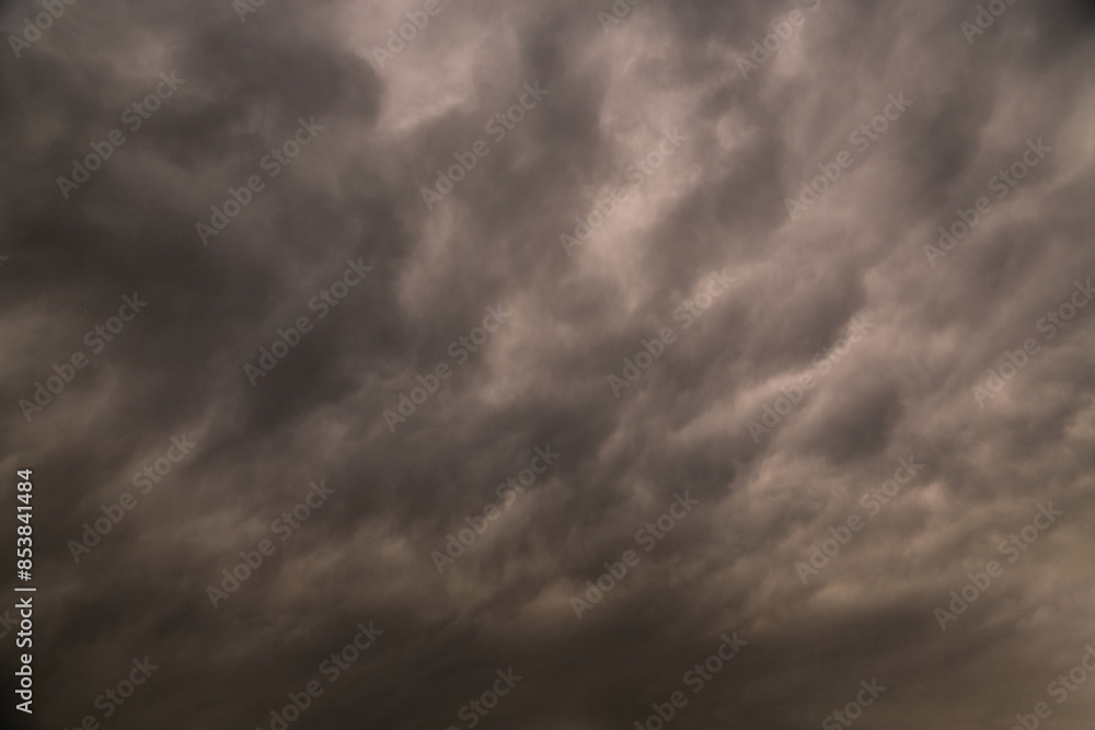 Obraz premium Gray storm clouds covering the sky, dramatic sky in gray tones, rain front