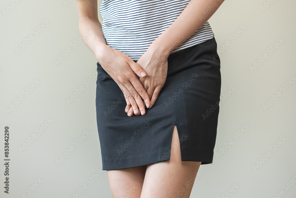 Vaginal, urinary incontinence. Pain asian young woman hand holding