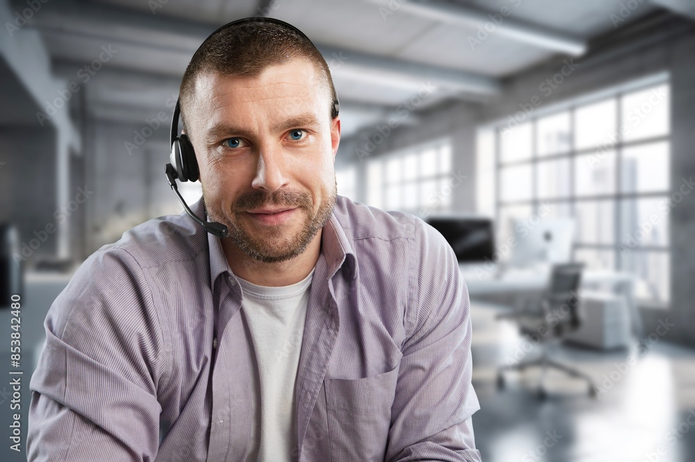 Smiling happy call center worker wearing headset Smiling happy call center worker wearing headset