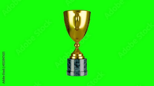 Golden trophy turning on green background 