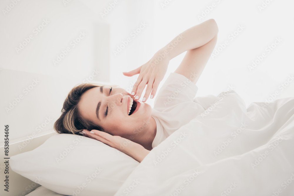 Photo of positive girl lying bed sleeping wake up in white day light room Photo of positive girl lying bed sleeping wake up in white day light room