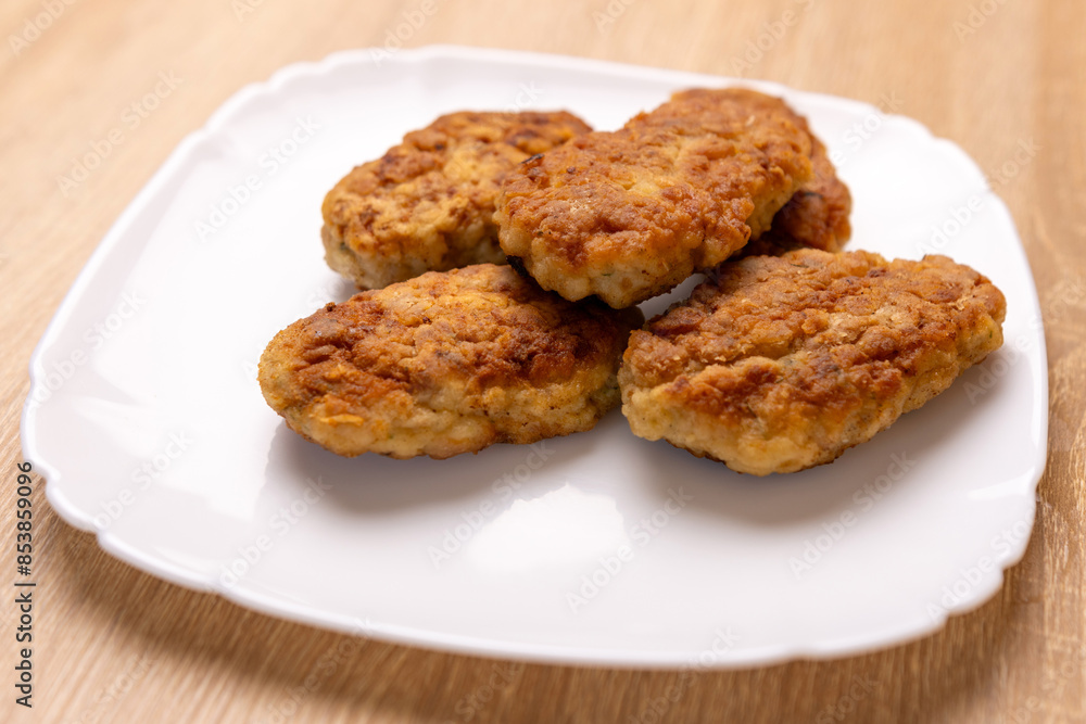 Freshly fried cutlets are placed on a plate. Freshly fried cutlets are placed on a plate.