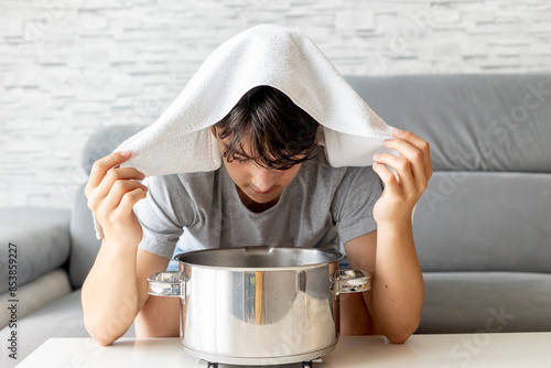 Cuadro en lienzo Teenage boy, child, doing steam inhalation at home to soothe and open nasal pass