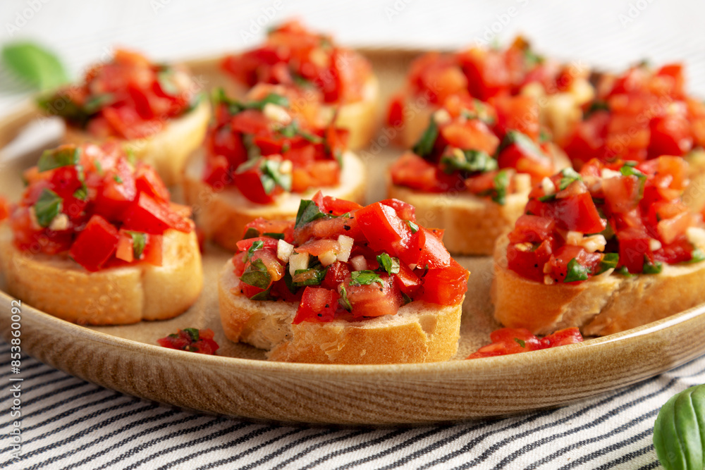 Homemade Italian Tomato Bruschetta on a Plate, side view. Close-up. Homemade Italian Tomato Bruschetta on a Plate, side view. Close-up.