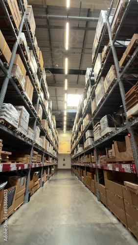 A warehouse filled with goods. The camera moves between rows in a warehouse filled with boxes. High quality 4k footage. High quality 4k footage