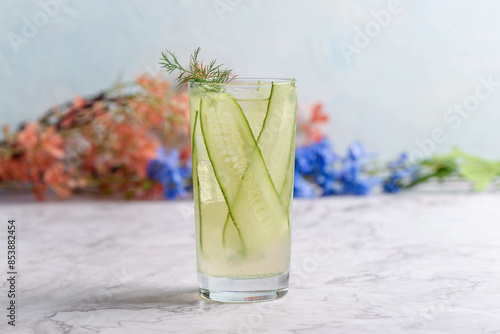 A refreshing cucumber mocktail made with thinly sliced cucumbers, lemonade and garnished with dill.
