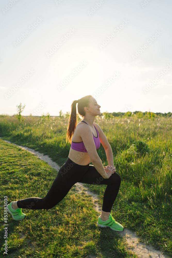 Beautiful girl doing fitness or yoga in nature on a sunny summer sunset. Body positive, sports for women, harmony, healthy lifestyle, self-love and wellness. Beautiful girl doing fitness or yoga in nature on a sunny summer sunset. Body positive, sports for women, harmony, healthy lifestyle, self-love and wellness.