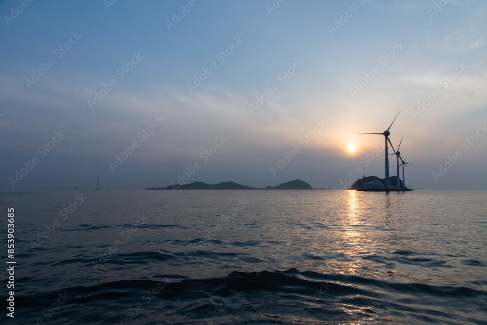 View of the wind turbines on the island during sunset View of the wind turbines on the island during sunset