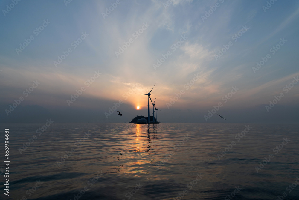 Fototapeta premium View of the wind turbines and flying seagulls during sunset on the sea
