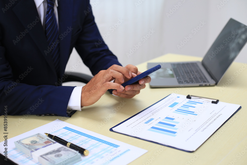 Looking at busy businessman's hands Using smartphones and laptops in the office, AI creates images. Looking at busy businessman's hands Using smartphones and laptops in the office, AI creates images.