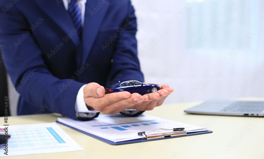 Car insurance documents or rental concept. A car broker helps his customers and explains the details of car contacts. Car keys. Buy or sell, sign. Car insurance documents or rental concept. A car broker helps his customers and explains the details of car contacts. Car keys. Buy or sell, sign.