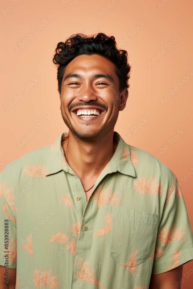 Fototapeta premium Portrait photo of a joyful Pacific Islander man, 33 years old, winking on a pastel beige background