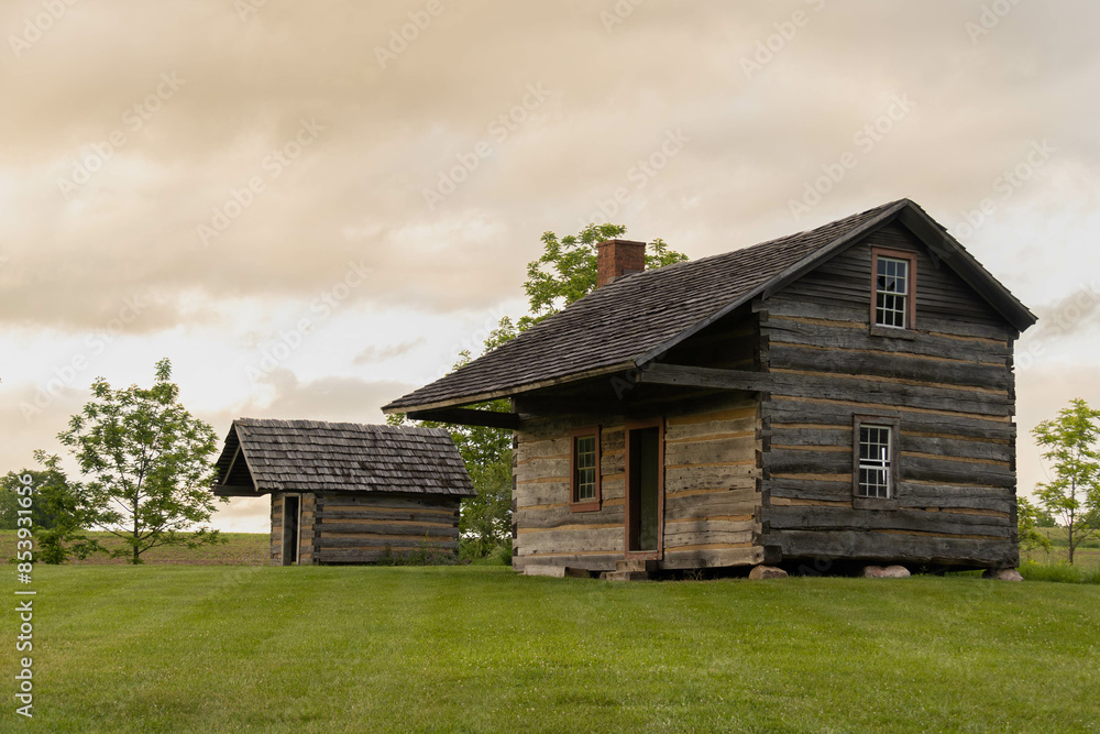 Indiana Pioneer homestead cabin in evening sunset light. Indiana Pioneer homestead cabin in evening sunset light.