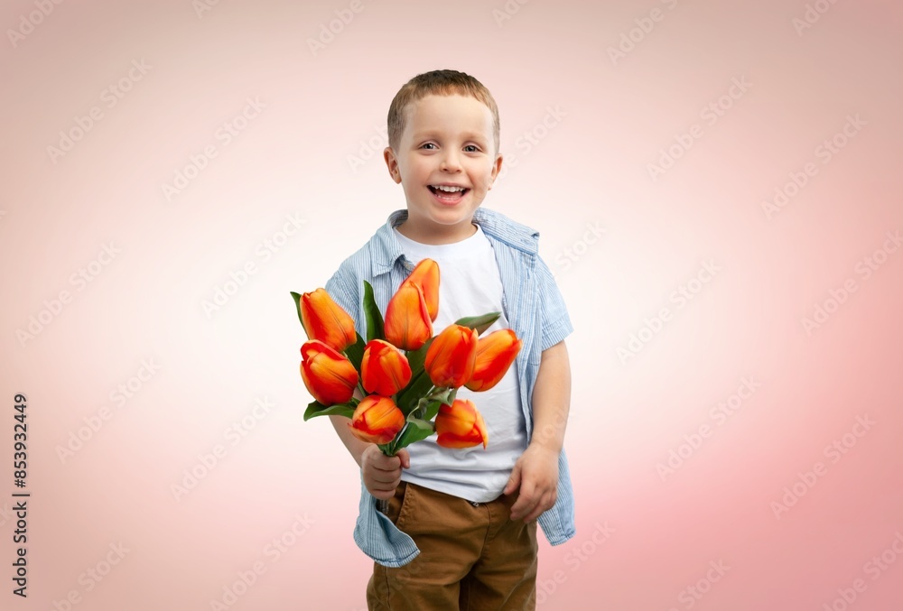 Cute charming child holds a bouquet of flowers Cute charming child holds a bouquet of flowers