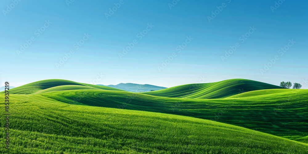 Naklejka premium Lush green rolling hills stretch out under a bright blue sky