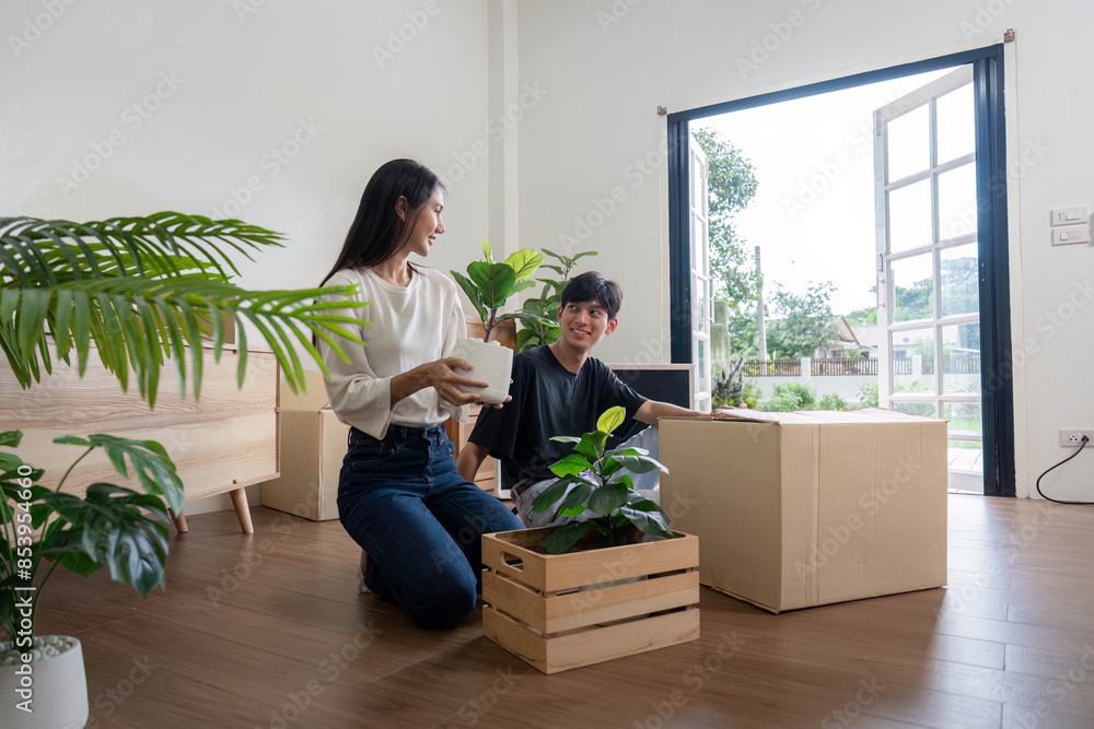 Happy Couple Moving into New Home with Boxes and Plants, Starting a New Chapter Together in a Bright and Modern Living Space Happy Couple Moving into New Home with Boxes and Plants, Starting a New Chapter Together in a Bright and Modern Living Space