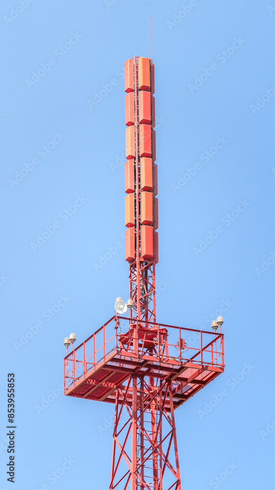 Tower red, cell signal splitter, Antennas and telecommunication equipment. Cell tower with antennas against a blue clear sky, concept of telecommunications equipment. Tower red, cell signal splitter, Antennas and telecommunication equipment. Cell tower with antennas against a blue clear sky, concept of telecommunications equipment.