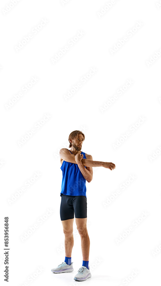 Warming up. Full-length of athletic man, runner with muscular fit body doing exercises before run isolated on white background. Concept of sport, marathon, competition, healthy and active lifestyle Warming up. Full-length of athletic man, runner with muscular fit body doing exercises before run isolated on white background. Concept of sport, marathon, competition, healthy and active lifestyle