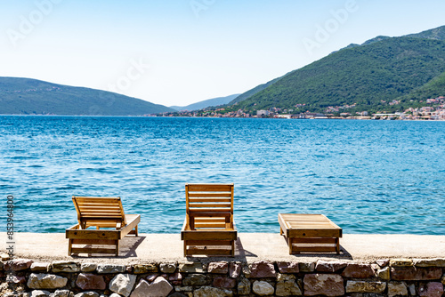 chairs on the beach overlooking bay of kotor