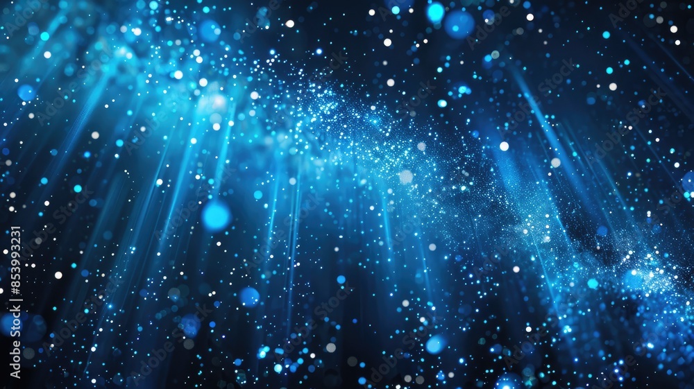 Abstract blue lights and particles with rays of light on a dark ...