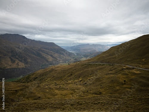 Panoramic view from Crown Range Road down into grass valley near Arrowtown Otago South Island New Zealand