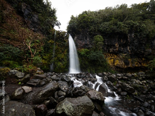 Long exposure of Dawson Falls Te Rere O Kapuni waterfall on the lush green bush slopes of Mount Taranaki New Zealand photo