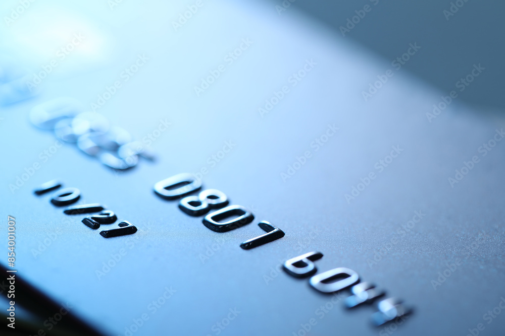 One credit card on blurred background, macro view One credit card on blurred background, macro view