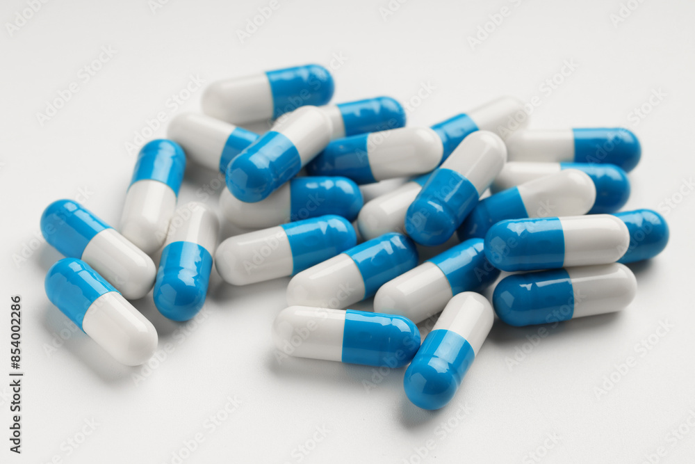 Many antibiotic pills on white background, closeup Many antibiotic pills on white background, closeup