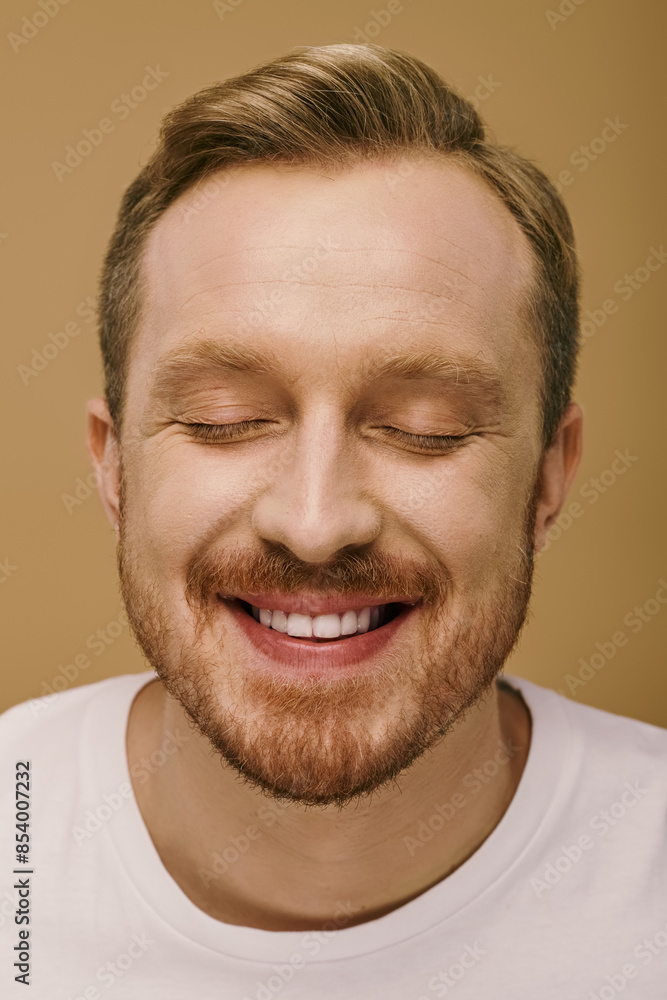 Man in stylish attire, eyes shut, smiling radiantly. Man in stylish attire, eyes shut, smiling radiantly.