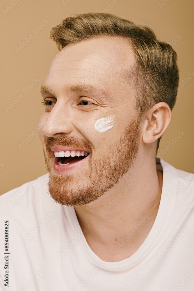 Fototapeta premium A bearded man in casual attire with cream.