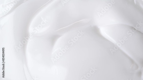 Macro shot of white smooth cosmetics cream, cream texture. Beauty facial cosmetics mask, closeup.