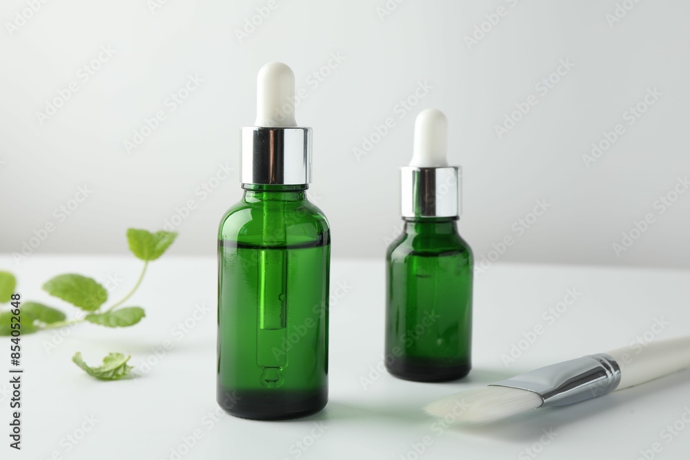 Bottles of chemical peel and brush on light background, closeup. Peeling procedure Bottles of chemical peel and brush on light background, closeup. Peeling procedure