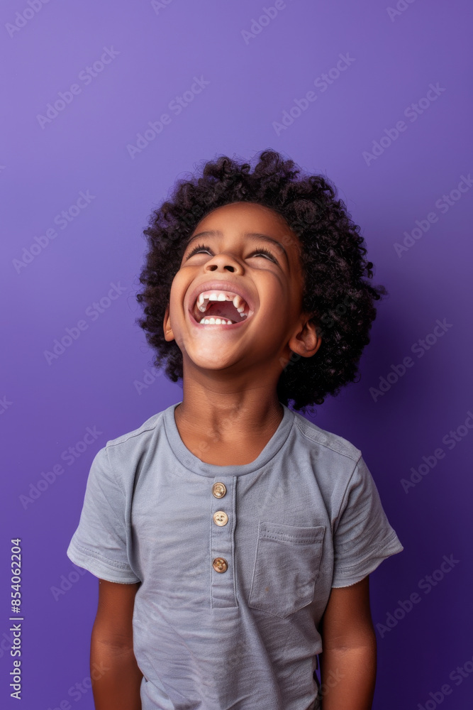 an African American child feeling joyful on a purple studio background an African American child feeling joyful on a purple studio background