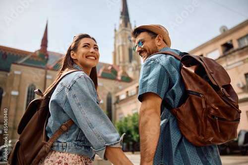 Young happy couple walking in  city while traveling together. photo