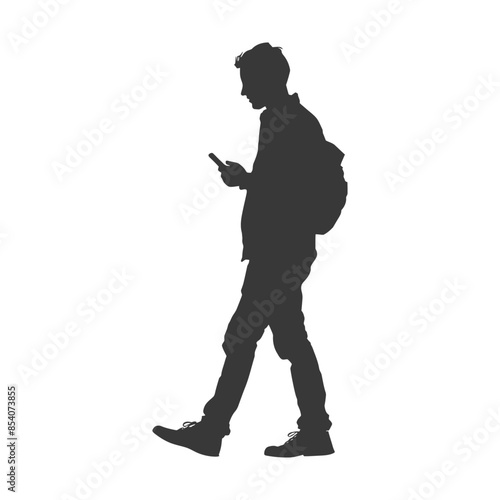 Silhouette of a walking man with backpack absorbed in his smartphone.