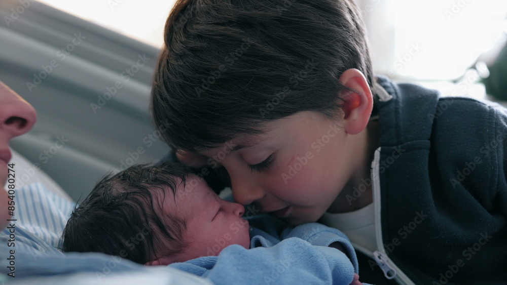 Heartwarming Family Moment - Young Boy Giving Eskimo Kiss to Newborn Brother in Hospital, siblings meeting for the first time after childbirth, authentic real life caring moment Heartwarming Family Moment - Young Boy Giving Eskimo Kiss to Newborn Brother in Hospital, siblings meeting for the first time after childbirth, authentic real life caring moment