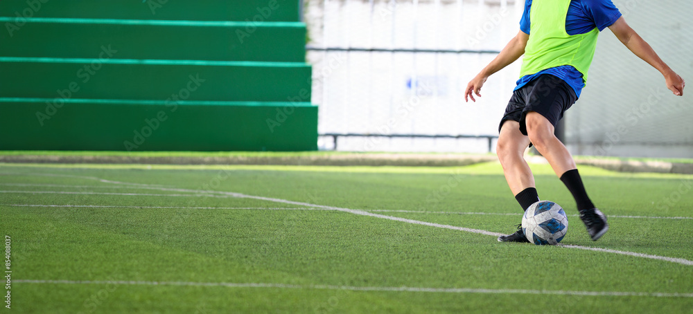 Soccer players in action during a game on a grass field, focusing on their legs and the ball. Soccer players in action during a game on a grass field, focusing on their legs and the ball.