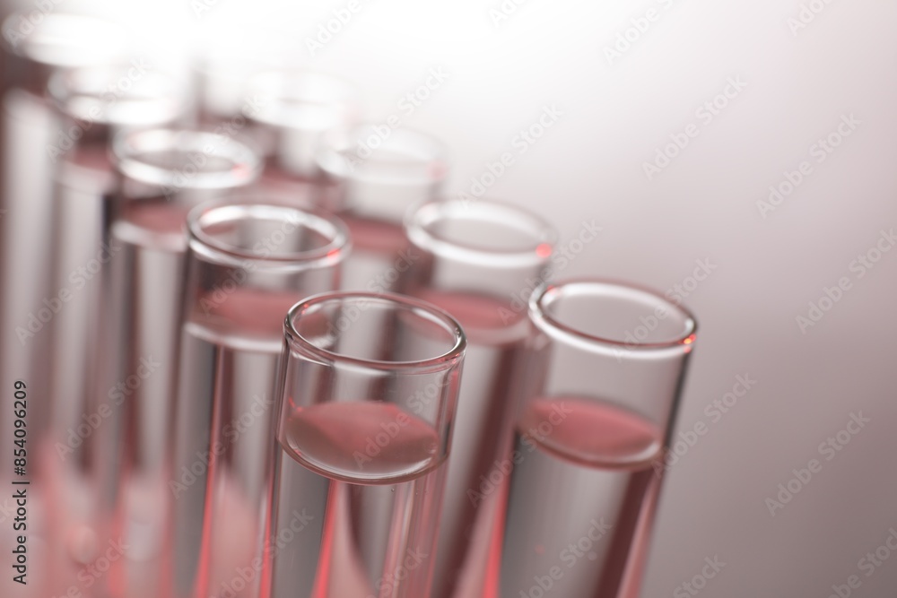 Many glass test tubes on light background, closeup Many glass test tubes on light background, closeup